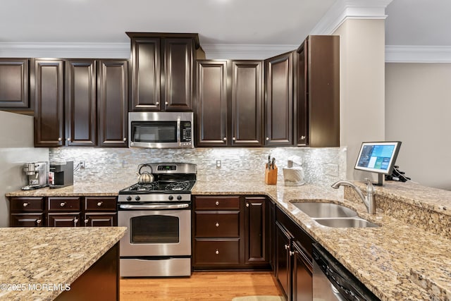 38 Phillip E Frank Way Unit 38, Cliffwood, NJ 07721 - kitchen featuring stainless steel appliances, light stone counters, light wood-style floors, crown molding, and dark brown cabinets