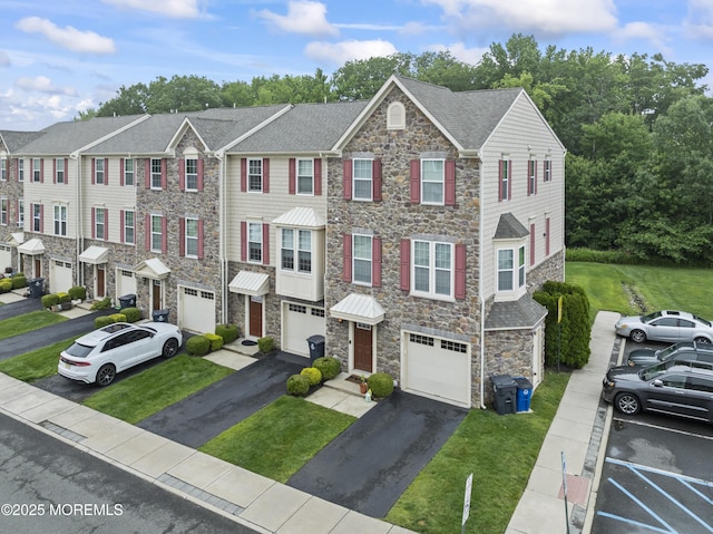 38 Phillip E Frank Way Unit 38, Cliffwood, NJ 07721 - view of property featuring stone siding, driveway, an attached garage, and a front yard