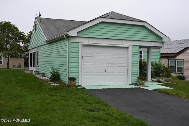 22 Elmswell Ave, Manchester, NJ 08759 - view of front of property with roof with shingles, an attached garage, a front lawn, and asphalt driveway