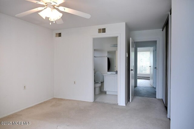 22 Elmswell Ave, Manchester, NJ 08759 - unfurnished bedroom with carpet flooring, a baseboard heating unit, connected bathroom, and ceiling fan