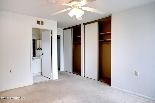 22 Elmswell Ave, Manchester, NJ 08759 - unfurnished bedroom featuring light carpet, multiple closets, ensuite bath, and ceiling fan
