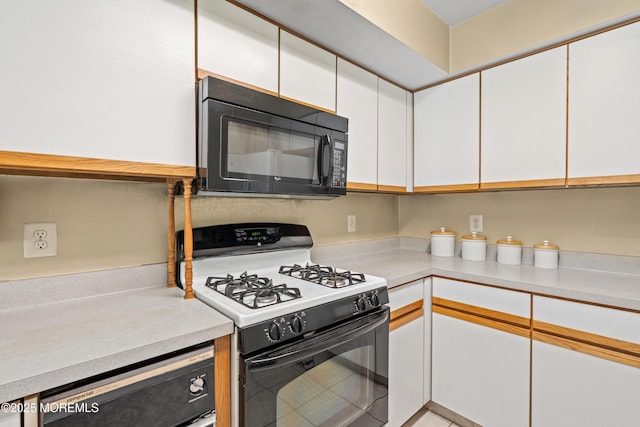 74 Mc Kinley Dr, Ocean Twp, NJ 07712 - kitchen featuring gas stove, black microwave, white cabinets, light countertops, and dishwasher