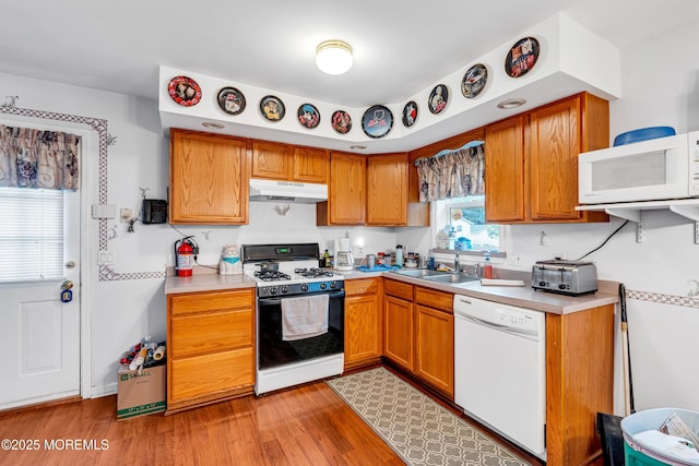 532 Georgia Tavern Rd, Howell, NJ 07731 - kitchen with white appliances, under cabinet range hood, light countertops, and light wood-style floors