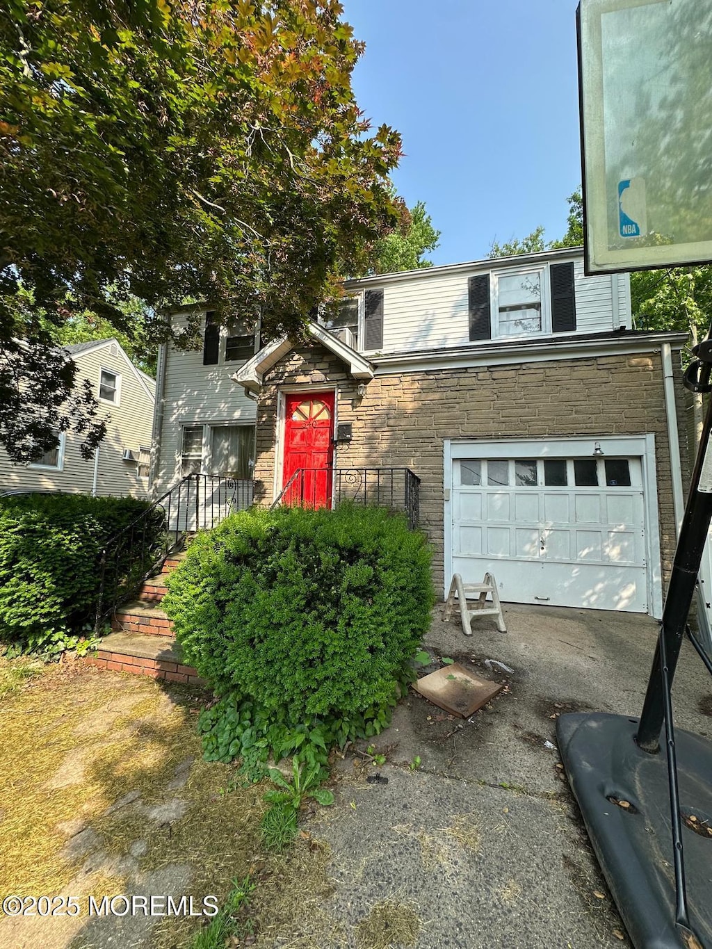 540 W 7th Ave, Roselle, NJ 07203 - traditional-style house featuring driveway, stone siding, and a garage