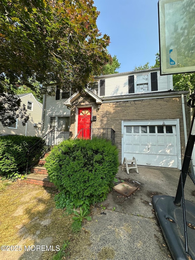 540 W 7th Ave, Roselle, NJ 07203 - traditional-style house featuring driveway, stone siding, and a garage