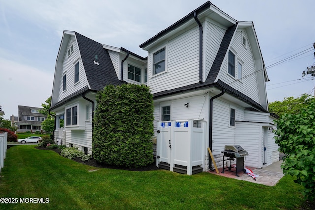 342 Lincoln Ave, Avon-By-The-Sea, NJ 07717 - back of property with a gambrel roof, a lawn, a shingled roof, and a patio