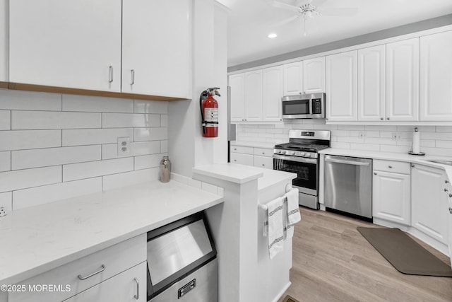 342 Lincoln Ave, Avon-By-The-Sea, NJ 07717 - kitchen featuring stainless steel appliances, backsplash, white cabinetry, recessed lighting, and light wood-type flooring