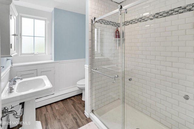 342 Lincoln Ave, Avon-By-The-Sea, NJ 07717 - bathroom with baseboard heating, a wainscoted wall, a shower stall, and wood finished floors