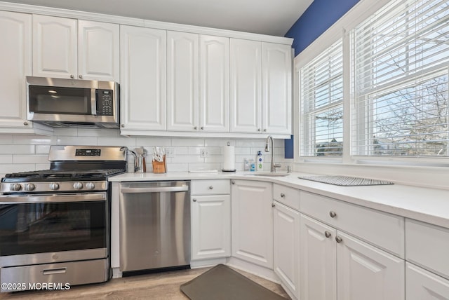 342 Lincoln Ave, Avon-By-The-Sea, NJ 07717 - kitchen featuring appliances with stainless steel finishes, white cabinetry, and tasteful backsplash