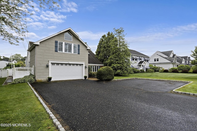 14 W St, Monmouth Beach, NJ 07750 - traditional-style house featuring asphalt driveway, an attached garage, and a residential view