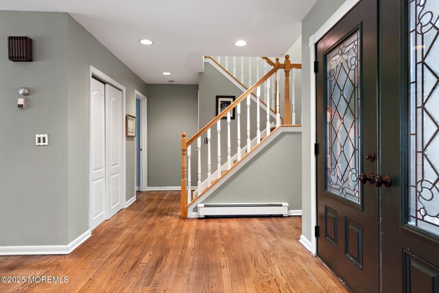 14 W St, Monmouth Beach, NJ 07750 - foyer entrance with a baseboard heating unit, wood finished floors, stairs, and recessed lighting