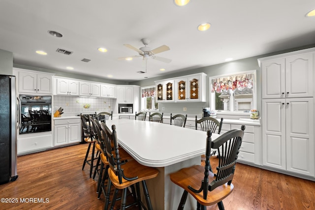14 W St, Monmouth Beach, NJ 07750 - kitchen with appliances with stainless steel finishes, a breakfast bar, a warming drawer, ceiling fan, and white cabinetry