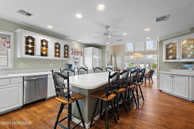 14 W St, Monmouth Beach, NJ 07750 - kitchen featuring stainless steel dishwasher, a breakfast bar, white cabinets, a chandelier, and recessed lighting