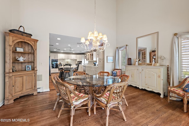 14 W St, Monmouth Beach, NJ 07750 - dining room with a high ceiling, dark wood-type flooring, a chandelier, healthy amount of natural light, and a baseboard radiator