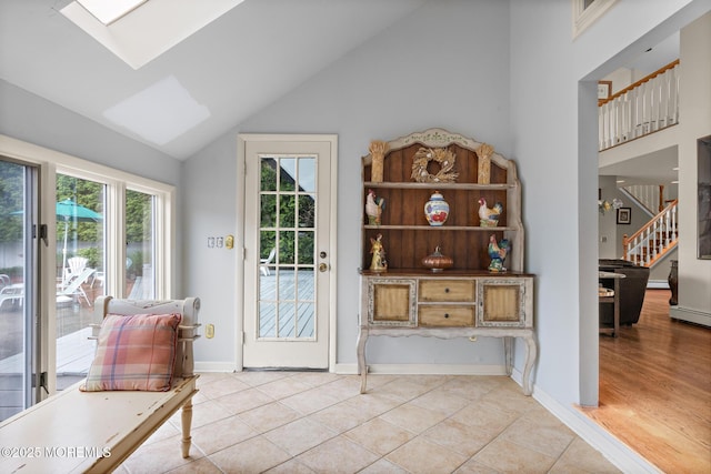 14 W St, Monmouth Beach, NJ 07750 - doorway with a skylight, high vaulted ceiling, stairs, light tile patterned floors, and a baseboard radiator