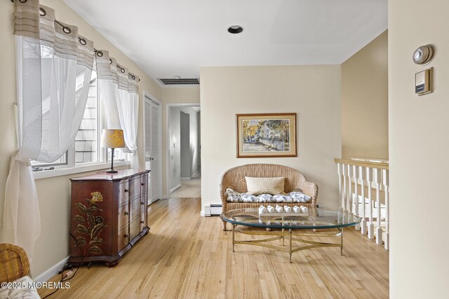 14 W St, Monmouth Beach, NJ 07750 - living area featuring wood finished floors and a baseboard heating unit