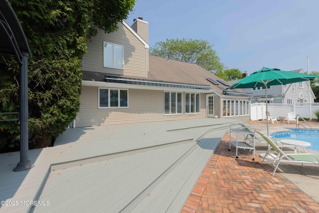 14 W St, Monmouth Beach, NJ 07750 - rear view of house with a deck, a chimney, a patio area, and roof with shingles
