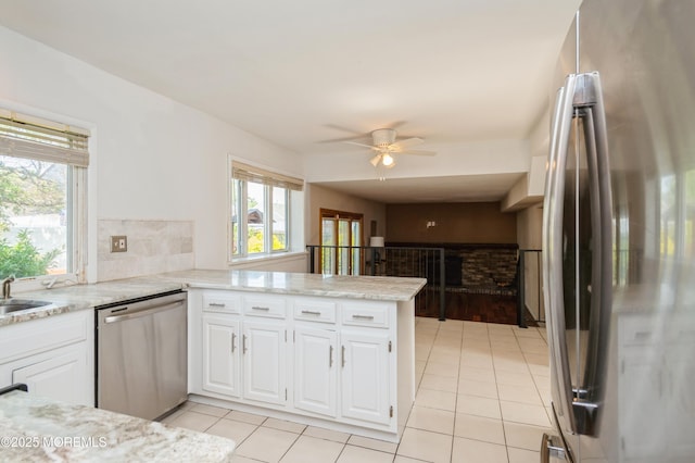 892 Eaglehurst Rd, Toms River, NJ 08753 - kitchen with appliances with stainless steel finishes, plenty of natural light, a peninsula, and light tile patterned floors