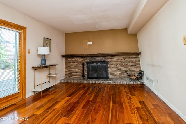 892 Eaglehurst Rd, Toms River, NJ 08753 - unfurnished living room with wood finished floors and a brick fireplace