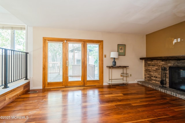 892 Eaglehurst Rd, Toms River, NJ 08753 - unfurnished living room with healthy amount of natural light, hardwood / wood-style floors, and a brick fireplace