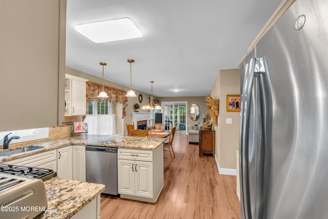 37 Normanton Ave, Manchester, NJ 08759 - kitchen with appliances with stainless steel finishes, light wood-style flooring, white cabinetry, and a peninsula