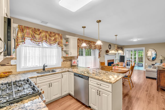 37 Normanton Ave, Manchester, NJ 08759 - kitchen with stainless steel dishwasher, open floor plan, light wood-type flooring, a fireplace, and decorative backsplash