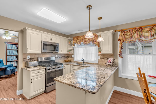 37 Normanton Ave, Manchester, NJ 08759 - kitchen featuring appliances with stainless steel finishes, light wood finished floors, tasteful backsplash, open shelves, and hanging light fixtures