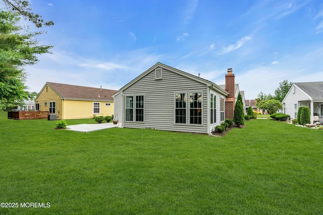 37 Normanton Ave, Manchester, NJ 08759 - back of house with a patio, a chimney, and a lawn