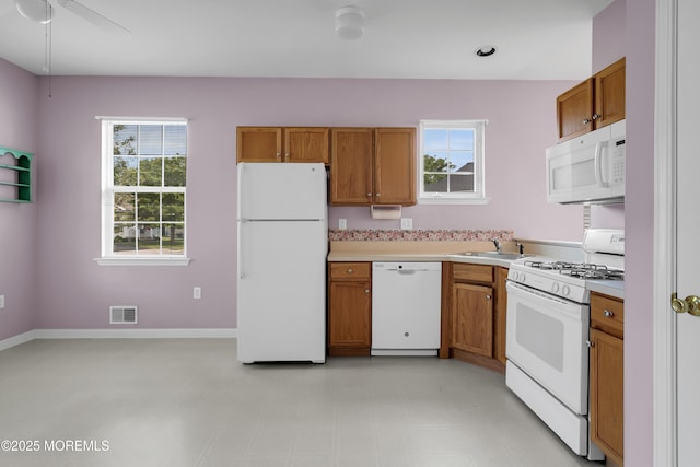 48 Wordsworth Rd, Brick, NJ 08724 - kitchen with white appliances, brown cabinetry, and light countertops