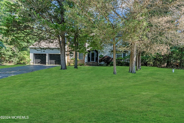 4 W Dickens Ct, Jackson, NJ 08527 - view of property hidden behind natural elements featuring driveway, a front yard, and a garage