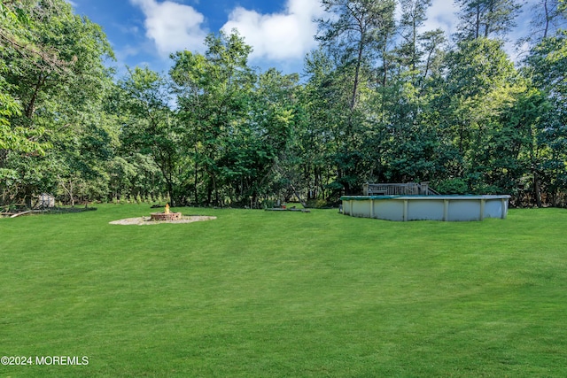 4 W Dickens Ct, Jackson, NJ 08527 - view of grassy yard featuring an outdoor pool and an outdoor fire pit