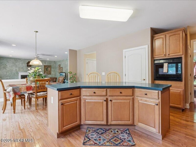 1 Turtle Clan Ct, Clarksburg, NJ 08510 - kitchen featuring oven, dark countertops, light wood-style flooring, and a kitchen island