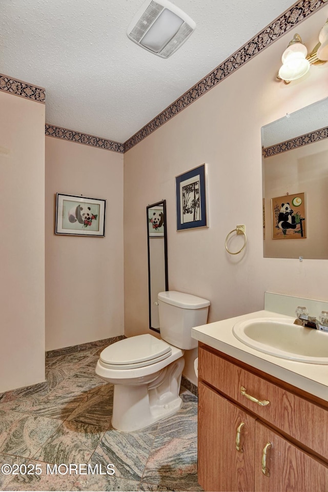 28 Tulip Ct, Howell, NJ 07731 - half bathroom with toilet, vanity, and a textured ceiling