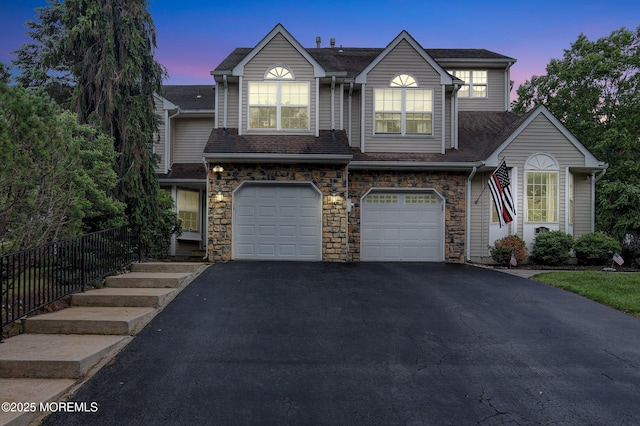 28 Tulip Ct, Howell, NJ 07731 - view of front facade with an attached garage, driveway, stone siding, and a shingled roof