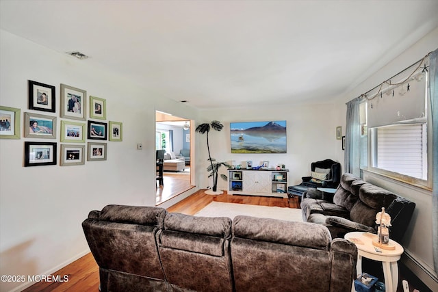 855 Derry Dr, Toms River, NJ 08753 - living area featuring wood finished floors and a baseboard heating unit