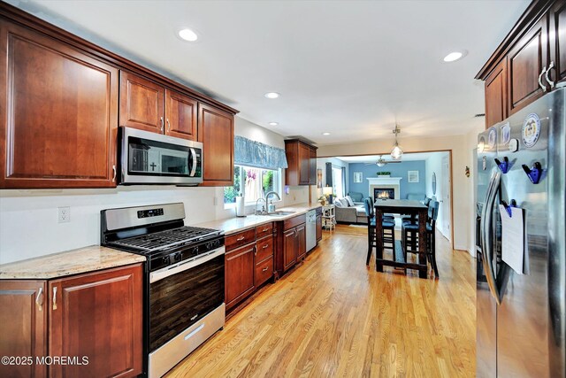855 Derry Dr, Toms River, NJ 08753 - kitchen with appliances with stainless steel finishes, light wood-style floors, recessed lighting, open floor plan, and light stone counters