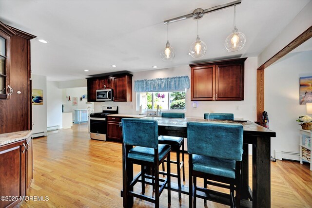 855 Derry Dr, Toms River, NJ 08753 - kitchen with stainless steel appliances, light wood finished floors, decorative light fixtures, recessed lighting, and a baseboard heating unit