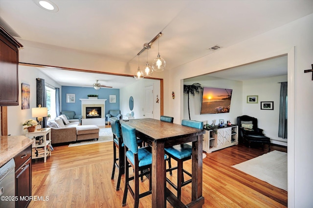 855 Derry Dr, Toms River, NJ 08753 - dining room featuring light wood finished floors, a ceiling fan, a glass covered fireplace, and baseboard heating