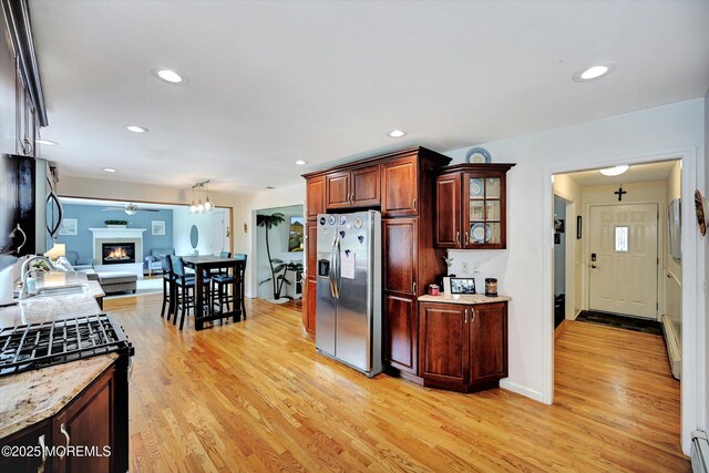 855 Derry Dr, Toms River, NJ 08753 - kitchen with stainless steel fridge with ice dispenser, light wood-style floors, a baseboard heating unit, range with gas cooktop, and glass insert cabinets