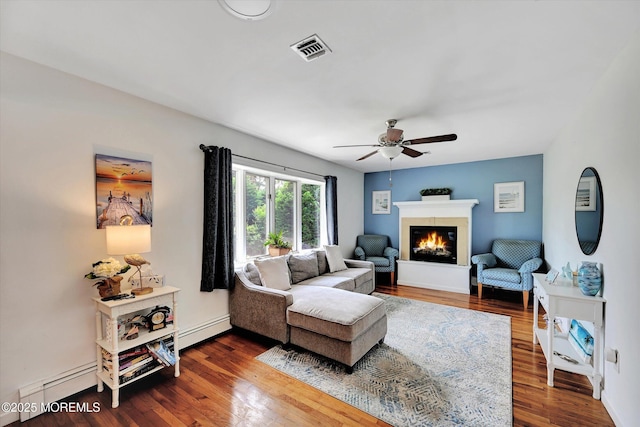 855 Derry Dr, Toms River, NJ 08753 - living area with a baseboard radiator, a glass covered fireplace, dark wood-type flooring, and a ceiling fan
