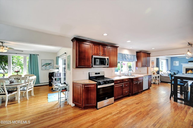 855 Derry Dr, Toms River, NJ 08753 - kitchen with appliances with stainless steel finishes, a ceiling fan, light wood finished floors, light countertops, and open floor plan