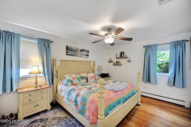 855 Derry Dr, Toms River, NJ 08753 - bedroom featuring a baseboard heating unit, a ceiling fan, and light wood finished floors