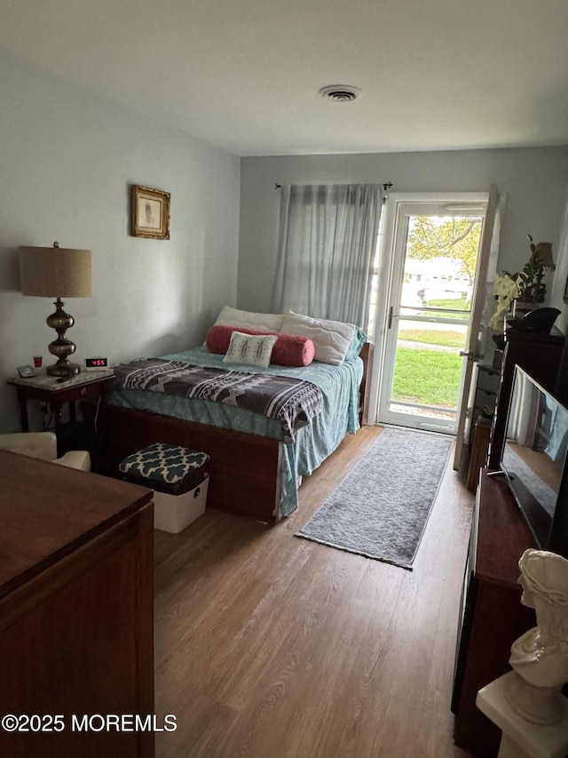 17E Cambridge Cir, Manchester, NJ 08759 - bedroom with access to exterior and wood finished floors