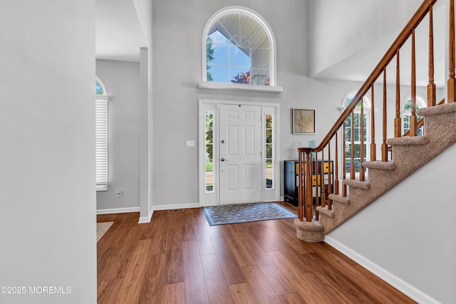 6 Hoffer Ct, Marlboro, NJ 07746 - entryway with healthy amount of natural light, hardwood / wood-style floors, stairway, and a high ceiling