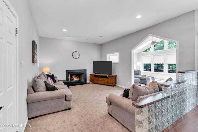 6 Hoffer Ct, Marlboro, NJ 07746 - carpeted living room featuring healthy amount of natural light, a warm lit fireplace, a ceiling fan, and recessed lighting