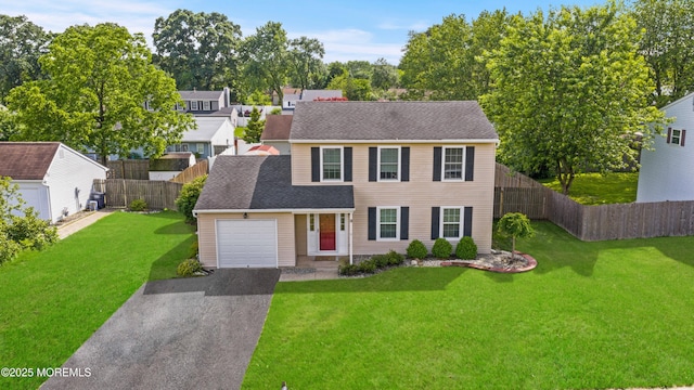 3 Mendon Dr, Howell, NJ 07731 - view of front of house with asphalt driveway, a garage, a fenced backyard, and roof with shingles
