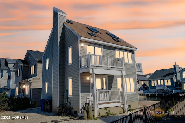 443 Harding Ave, Ortley Beach, NJ 08751 - back of house at dusk with a balcony and a chimney