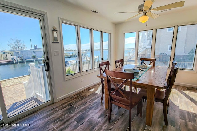 443 Harding Ave, Ortley Beach, NJ 08751 - dining room featuring a water view, ceiling fan, plenty of natural light, and dark wood-type flooring