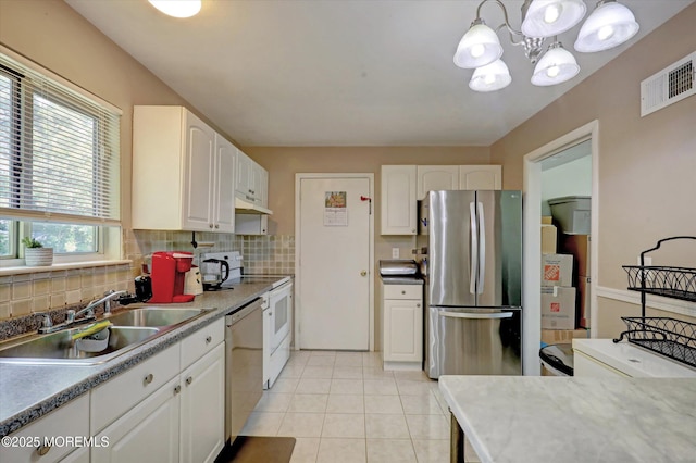 73 Barnegat Blvd S, Barnegat, NJ 08005 - kitchen featuring stainless steel appliances, tasteful backsplash, white cabinetry, a chandelier, and light tile patterned floors
