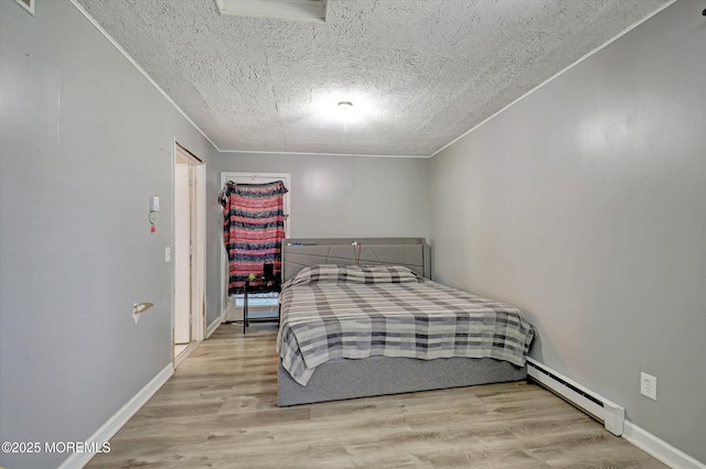 73 Barnegat Blvd S, Barnegat, NJ 08005 - bedroom featuring baseboard heating, a textured ceiling, and wood finished floors